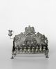 Hanukkah lamp adorned with Temple Menorah and hands raised for Priestly Benediction 