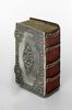 Bible book binding with five shaped chains on the spine, over red velvet