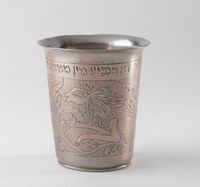 <div style='direction:ltr'>
    
          <strong>Cup made from silver coins
</strong><br />Decorated with images of a lion and a horse (?), the cup is inscribed in Hebrew: wThis beaker [is made] of coins of <i> tzaddikim</i>  and belongs to R. Shimon son of Yitzhak Meir.w
Photo © The Israel Museum, Jerusalem, by Elie Posner 

</p>


</div>